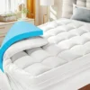 Mattress topper bed topper mattress pad white color, two pillows, on white mattress