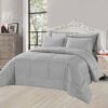 Dark Grey striped comforter set with matching pillow shams on a king-sized bed in a stylish bedroom with a white headboard and large window