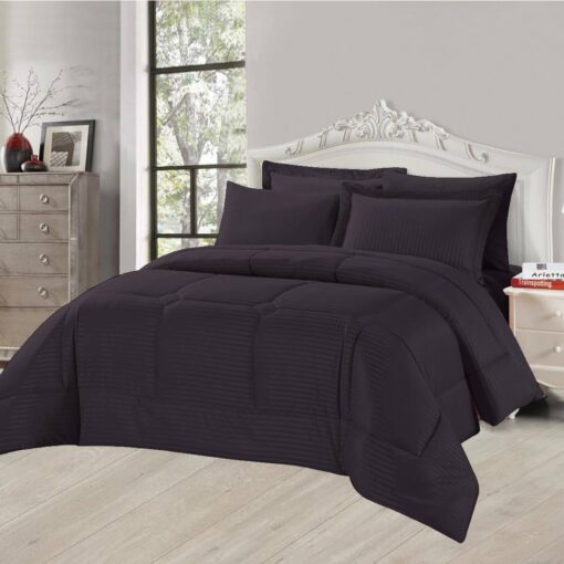 Dark Purple striped comforter set with matching pillow shams on a king-sized bed in a stylish bedroom with a white headboard and large window