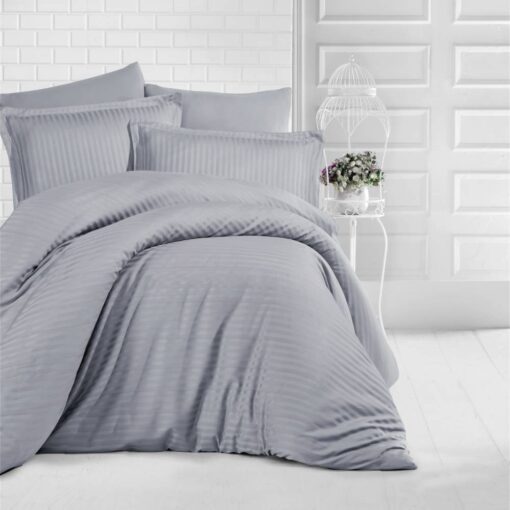 queen bed with silver stripe bed sheet and comforter on the bed adding a nice touch to the white room, stripe bed sheets and comforter set with four pillows